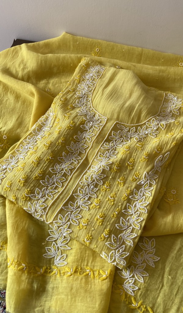 Yellow pure mul chanderi kurta piece folded, fine chikankari in view
