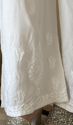 Chikankari at the hem of the white cotton palazzo, close up
