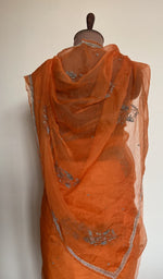 Embroidery on the tangerine orange saree, close view