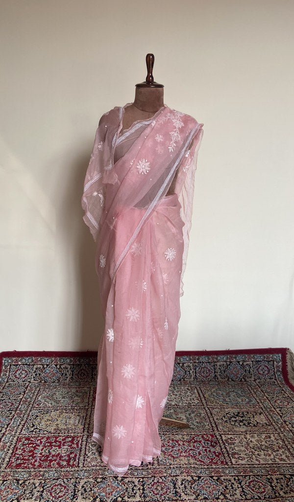 Baby pink organza silk saree draped on the mannequin, front view