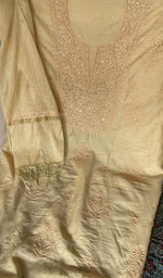 Motifs across the body of the beige kurta