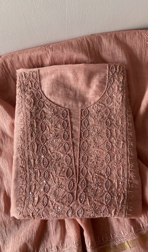 Deep peach pure mul chanderi kurta piece folded, fine chikankari on gala and boota with beads and sequins