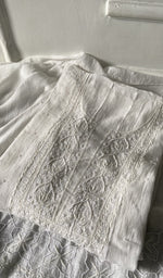 off white pure mul chanderi kurta piece folded, fine chikankari on neck and allover sleeve with beautiful be