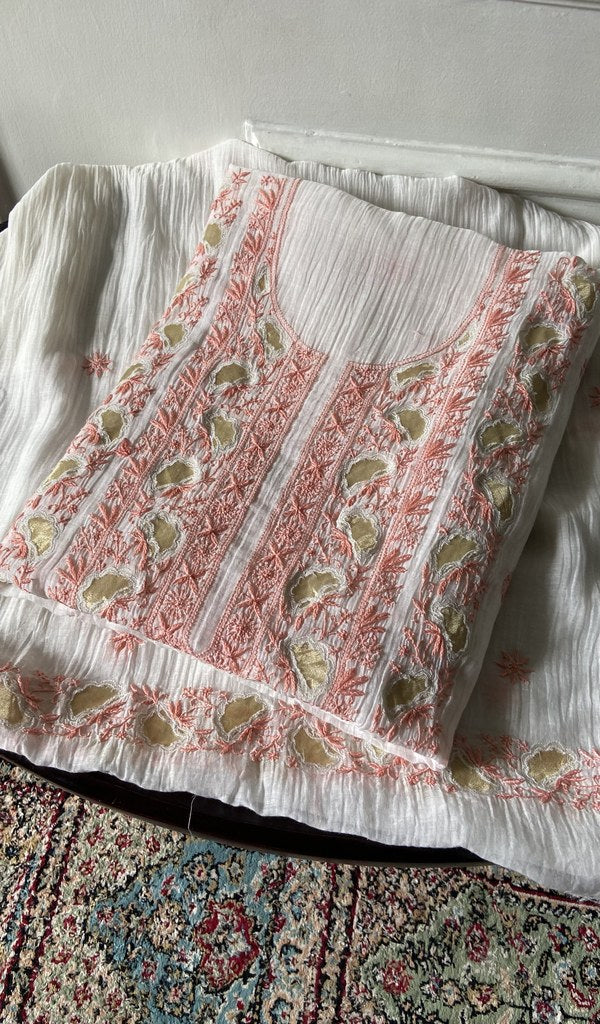 white chikankari set folded, worked panel on top