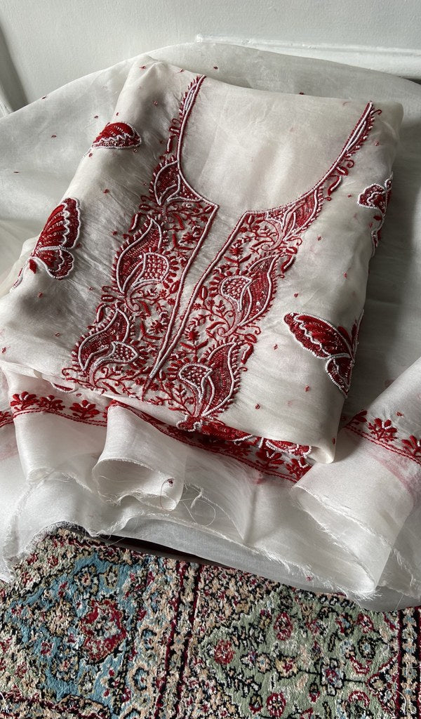 white chikankari set folded, worked panel on top