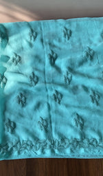 The turquoise kurta, spread out flat
