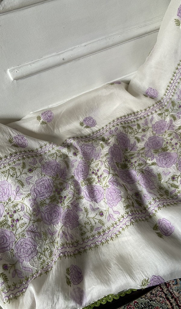 White kurta piece laid out, work across the body