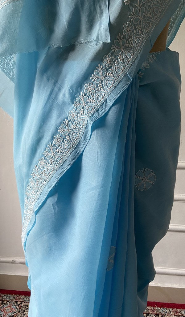 Powder blue saree draped to show the fall of the fabric