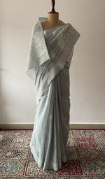 Sage Grey cotton voile chikankari saree draped on the mannequin