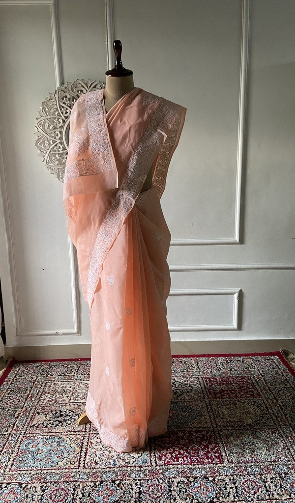 Peach cotton voile chikankari saree draped on the mannequin