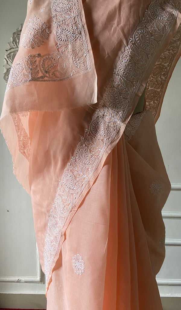Border detail on the peach cotton voile saree