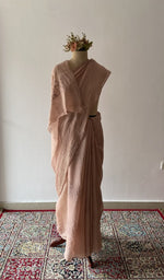 Beige pure mul chanderi saree draped on the mannequin