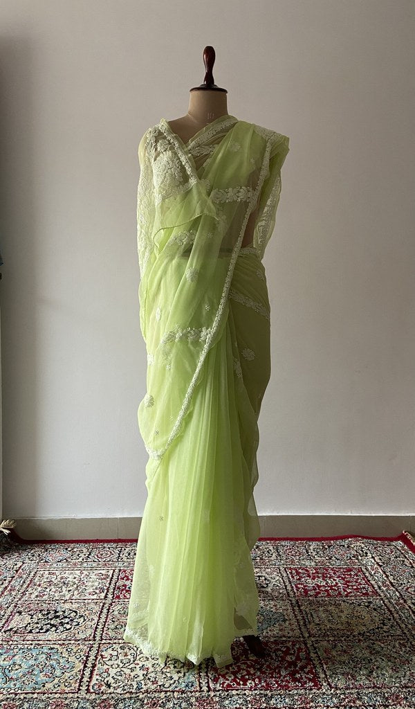 Green faux georgette saree draped on the mannequin