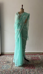 Turquoise faux georgette saree draped on the mannequin