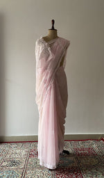 Pale pink faux georgette saree draped on the mannequin