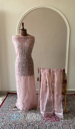 Dusty pink organza silk set on the mannequin with its dupatta