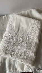 Folded kurta piece and dupatta, chikankari along the hem