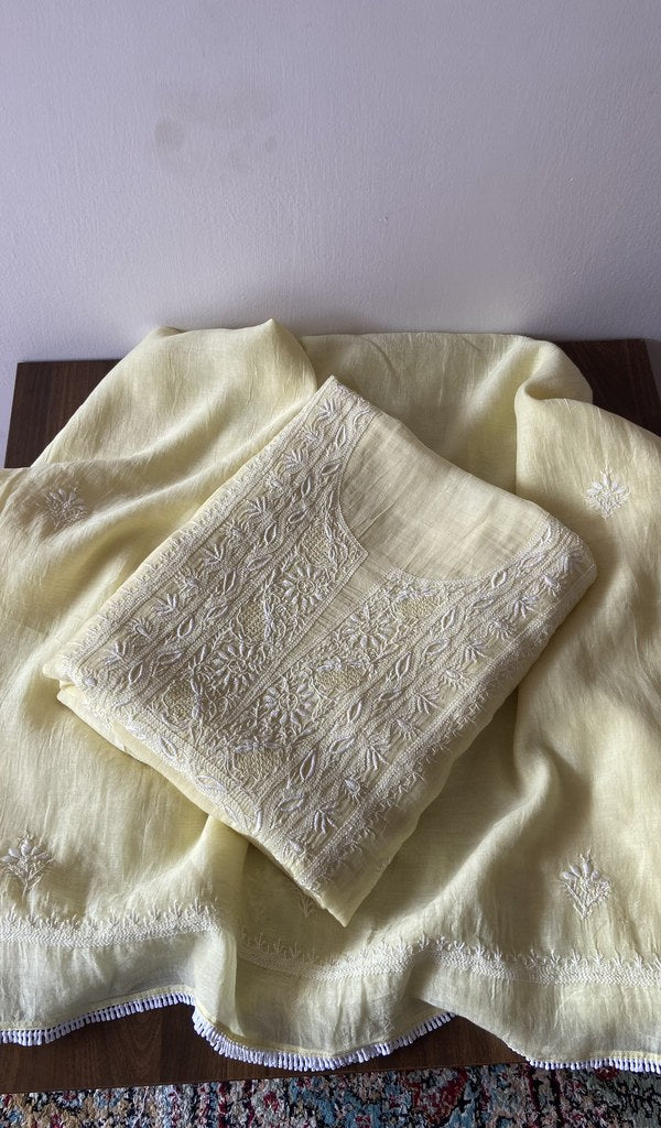 Folded yellow pure mul chanderi kurta piece with chikankari on the panel