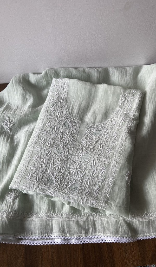 Folded green pure mul chanderi kurta piece with chikankari on the panel