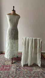 Green pure mul chanderi chikankari suit set on the mannequin with its dupatta