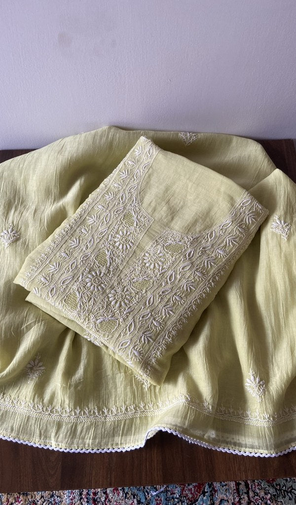 Folded yellow pure mul chanderi kurta piece with chikankari on the panel
