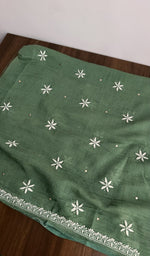 The dupatta spread out, bottle green mul chanderi