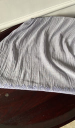 The kurta piece folded on the carpet