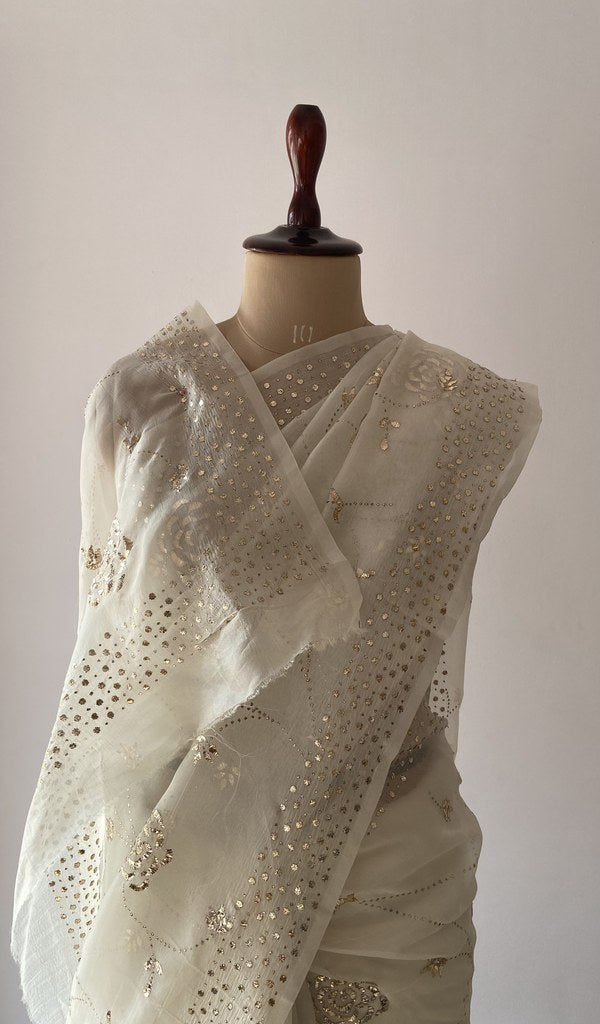 Off white pure organza silk saree draped on the mannequin