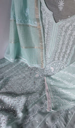 Motifs across the body of the turquoise kurta