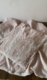 Folded pink pure mul chanderi kurta piece with chikankari on the panel