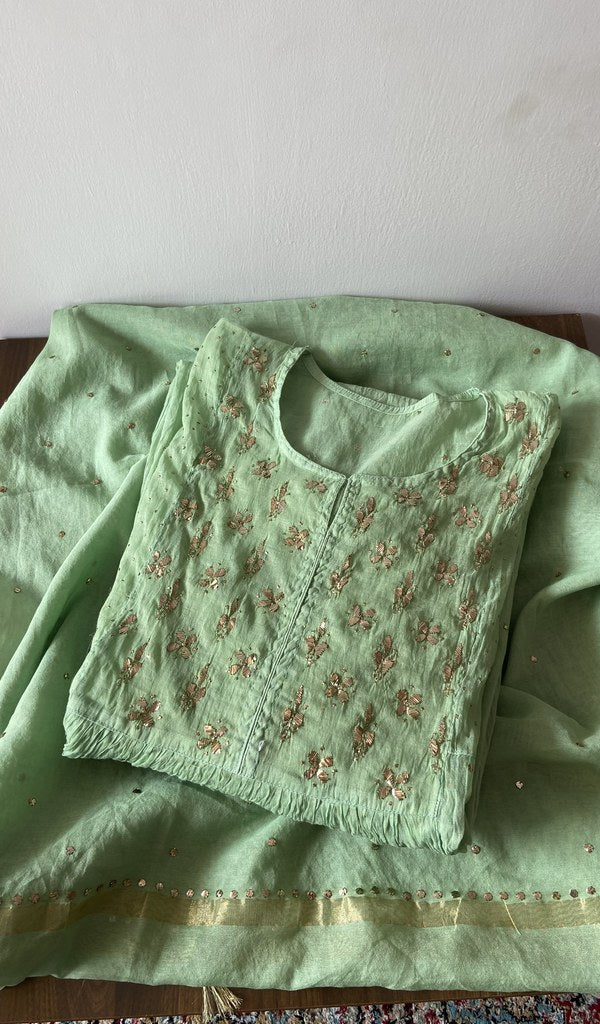Folded green pure mul chanderi kurta piece with chikankari on the panel