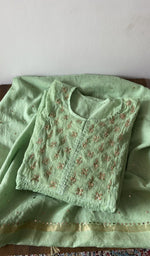 Folded green pure mul chanderi kurta piece with chikankari on the panel