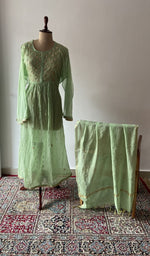 Green pure mul chanderi chikankari suit set on the mannequin with its dupatta
