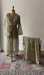Green pure mul chanderi chikankari suit set on the mannequin with its dupatta