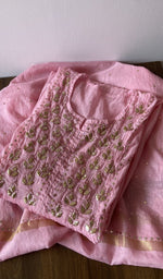 Folded pink pure mul chanderi kurta piece with chikankari on the panel