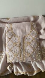 Folded kurta piece and dupatta, chikankari in gold thread along the hem