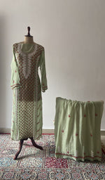 Green pure mul chanderi chikankari suit set on the mannequin with its dupatta