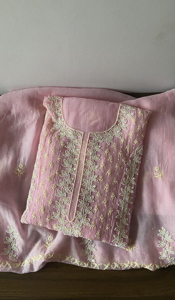 Folded pink pure mul chanderi kurta piece with chikankari in white thread on the panel