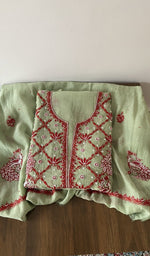 Folded green pure mul chanderi kurta piece with chikankari in red thread on the panel