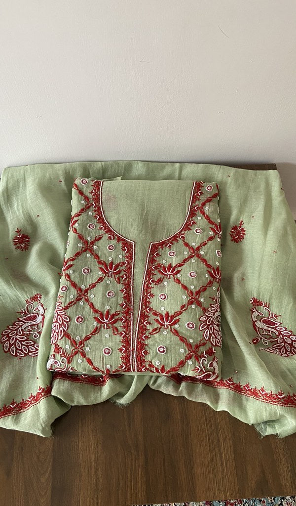 Folded green pure mul chanderi kurta piece with chikankari in red thread on the panel