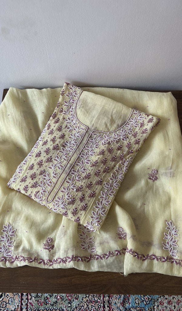 Folded yellow pure mul chanderi kurta piece with chikankari in lilac thread on the panel