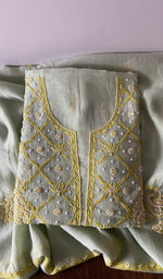 Folded kurta piece and dupatta, chikankari in gold thread along the hem