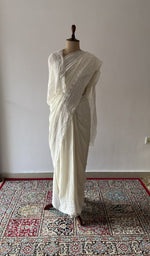 Off white pure silk georgette saree draped on the mannequin