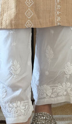 Hem embroidery on the white pant, up close