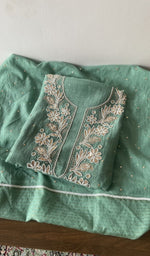Folded green pure mul chanderi kurta piece with chikankari on the panel