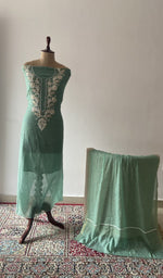 Green pure mul chanderi chikankari suit set on the mannequin with its dupatta