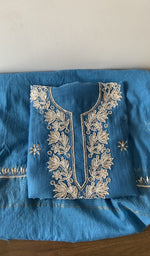 Folded blue pure mul chanderi kurta piece with chikankari on the panel