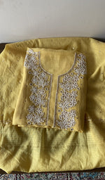 Folded yellow pure mul chanderi kurta piece with chikankari on the panel