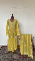 Mustard yellow mul chanderi set on the mannequin with its dupatta