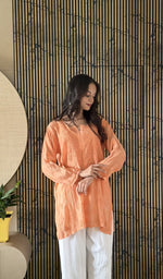 Orange short kurti on the model